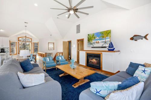 a living room with two couches and a fireplace at 1345 - Amarissa by the Sea in Corolla
