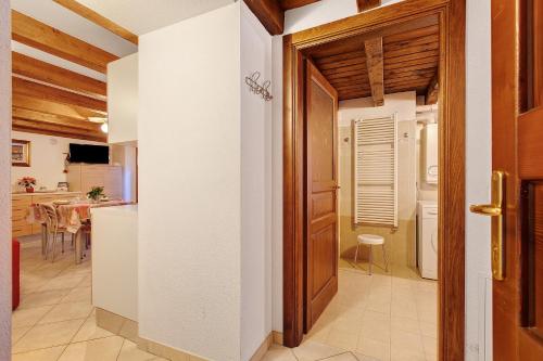 a kitchen with a door leading to a dining room at Le Bourg 61 - Aosta Centro in Aosta