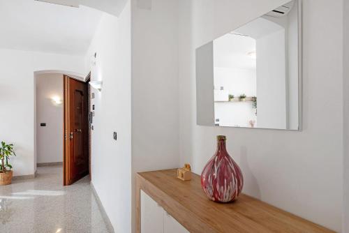 a vase sitting on a counter in a room at Mela Garden House in Genoa