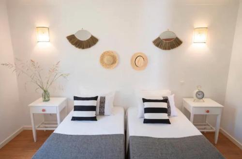 a bedroom with two beds and two night stands at Quinta da Romã in Olhão