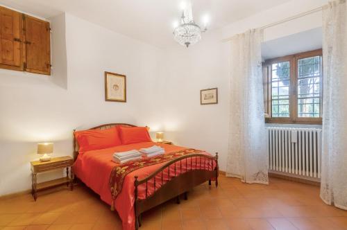 a bedroom with a bed with red sheets and a window at Villa Toscana a Fiesole in Florence