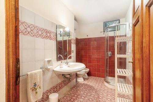 a bathroom with a sink and a toilet and a shower at Villa Toscana a Fiesole in Florence