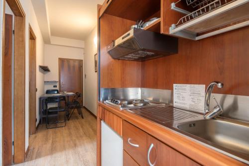 a kitchen with a sink and a stove top oven at Appartamento Bilocale Moneglia 22 in Moneglia