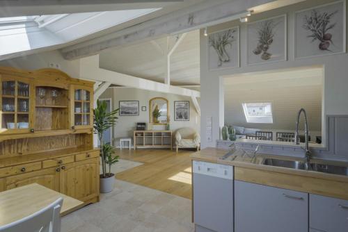 a kitchen and living room with a sink and a table at Happy Hugle Haus in Offenburg