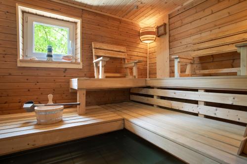 eine Holzhütte mit Badewanne und Fenster in der Unterkunft Julenhof in Loitz