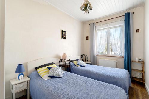 a bedroom with two beds and a window at Maison Pêcheur, jardin et plage -1 in Pornic