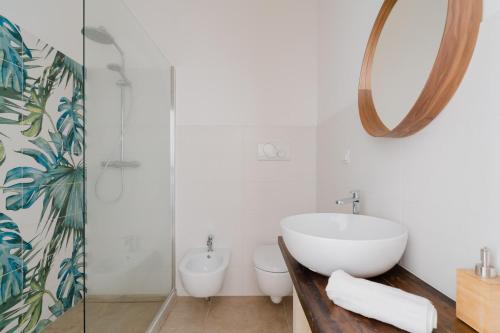 a bathroom with a sink and a toilet and a mirror at Casa Anastasia in Otranto