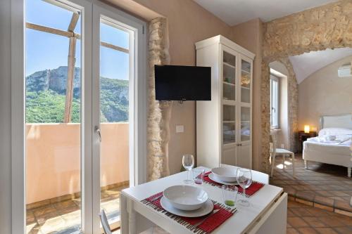 a living room with a table with wine glasses at Casa Virginia - Vigna in Orco Feglino