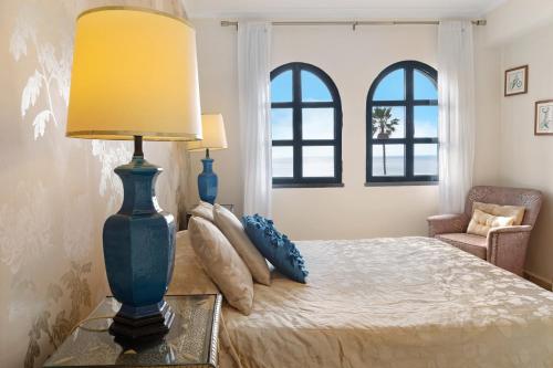 a bedroom with a bed with a lamp on a table at Luzias Apartment in Funchal