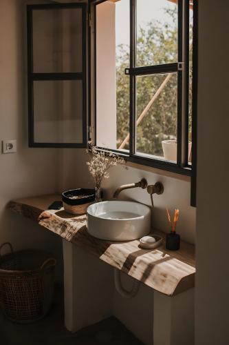 a bathroom counter with a sink and a window at Sa caseta mallorca Studio in Algaida