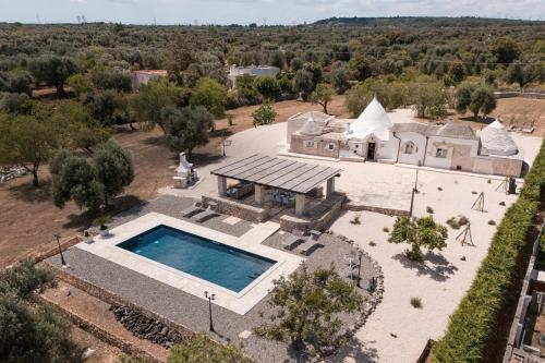an aerial view of a house with a swimming pool at Trulli Aletheia Con Piscina Privata in Ceglie Messapica