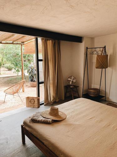 a bedroom with a bed with a hat on it at Sa caseta mallorca Studio in Algaida