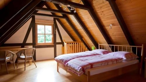 a bedroom with a bed in a attic at Drei Zinnen in Hiltpoltstein