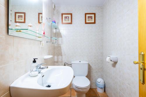 a bathroom with a white toilet and a sink at Casa Lino in Culla