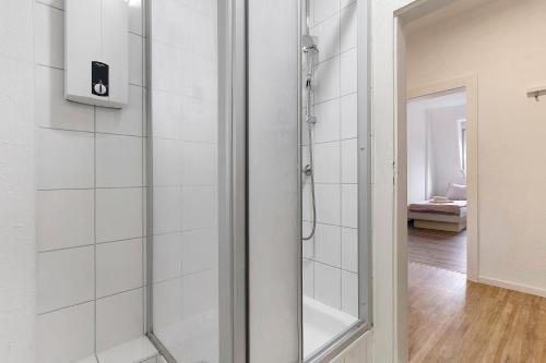 a shower with a glass door in a bathroom at Az-Living Feudenheim in Mannheim