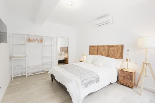 a white bedroom with a large bed with white walls at Casa Pablo City Center in Fuengirola