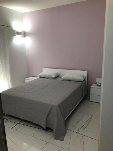 a bedroom with a bed with two pillows on it at Casa vacanze Capo Rizzuto 3 in Capo Rizzuto