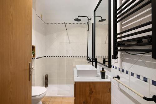 a bathroom with a sink and a toilet at Almadrava House in Tavira