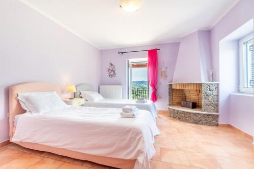 a bedroom with two beds and a fireplace at Ilios Country house in Arillas