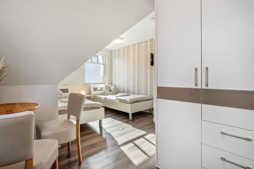 a living room and dining room with a table and chairs at Haus Windflüchter 3b in Zingst