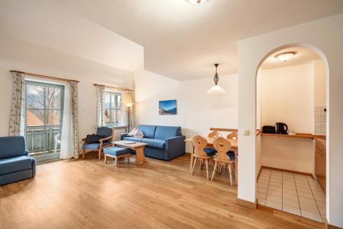 a living room with a couch and a table at Fewo Brünnstein - Nr 46 Pool, Sauna in Oberaudorf