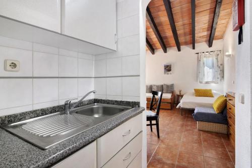 a kitchen with a sink and a room with a bed at Pedras Del Rei 26 in São Pedro