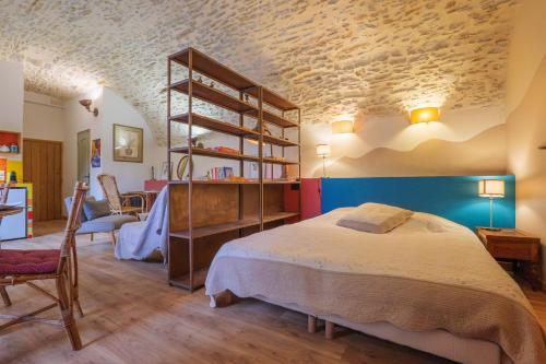 a bedroom with a bed and a book shelf at Studio De Caractère Classé 3 in Les Vans