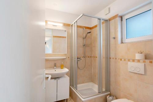 a bathroom with a shower and a sink and a toilet at Nordseezeit Strandnah u Poolrabatt in Butjadingen