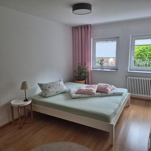 a bedroom with a bed with two pillows on it at Ferienwohnung Kleine Pause in Emmendingen