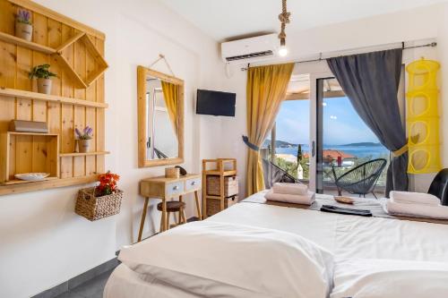 a bedroom with a bed and a view of the ocean at Oceanida Aelia room in Nikiana