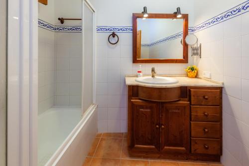 a bathroom with a sink and a mirror and a shower at S'alqueria Vell in Campanet