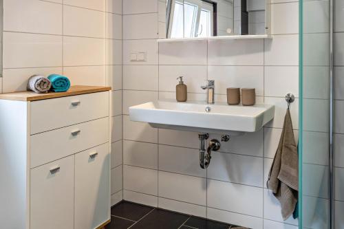 a bathroom with a sink and a mirror at Schmid am See in Gaienhofen