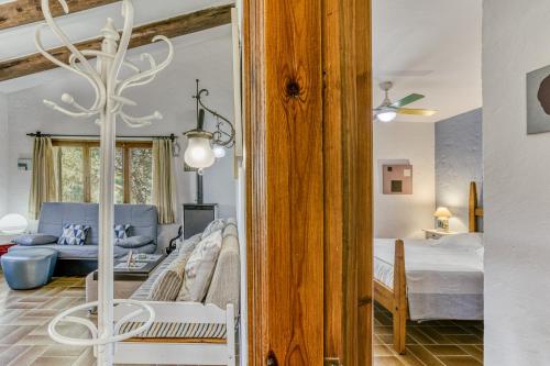 a bedroom with a bed and a living room at La Barraca de Farena in Palafrugell