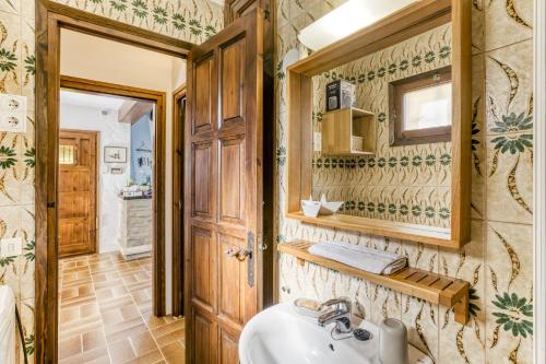 a bathroom with a sink and a mirror at La Barraca de Farena in Palafrugell