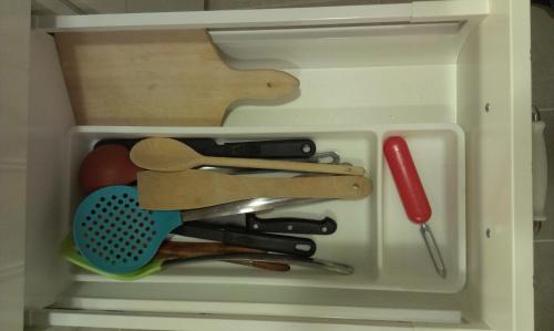 a white drawer filled with cooking utensils at Budanest Apartments in Budapest