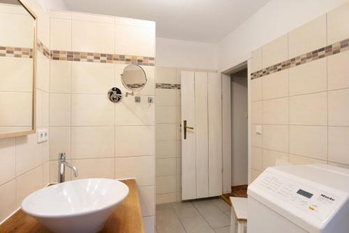 a bathroom with a white sink and a toilet at Idyllisches Bauernhaus in Gerswalde