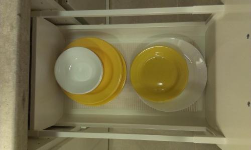 two plates and bowls sitting in a drawer at Budanest Apartments in Budapest
