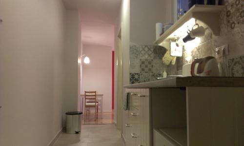 a kitchen with a counter and a table and a chair at Budanest Apartments in Budapest