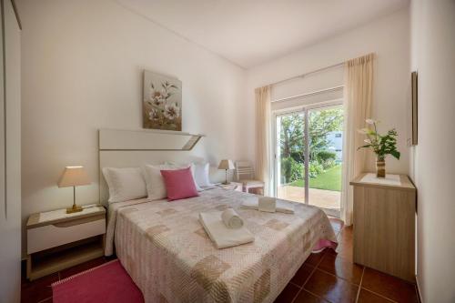 a bedroom with a bed with two towels on it at Villas Brites nº2 in Burgau