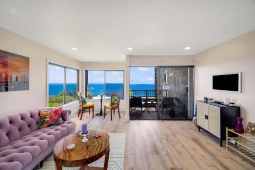 a living room with a couch and a table at Sealodge A2 Romantic Ocean View Oasis with Pool in Princeville