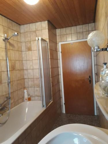 a bathroom with a shower and a tub and a toilet at Ferienwohnung Tante Martha in Monschau