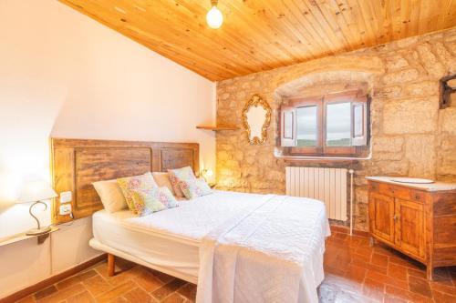 a bedroom with a bed and a wooden ceiling at Sant Grau I in Navés