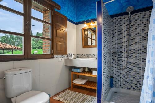 a bathroom with a toilet and a sink and a shower at Pedregal in Gijón