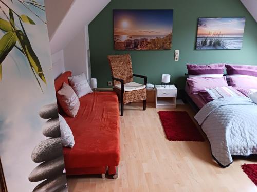 a bedroom with a bed and a couch and a chair at Ferienwohnung Gersch in Wolf
