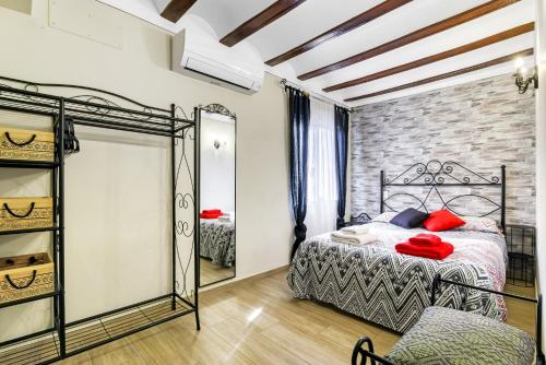 a bedroom with a bed and a mirror at Tío Salvador in Bolbaite