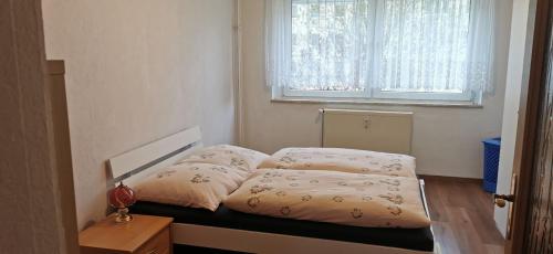 a bed in a room with a window at Ferienwohnung Mücheln 2 in Mücheln