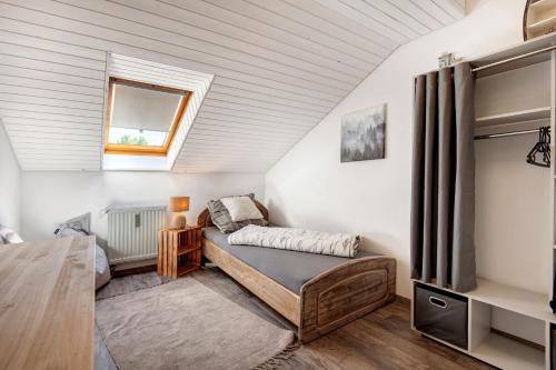 a bedroom with a bed and a window at Auenwald in Roding