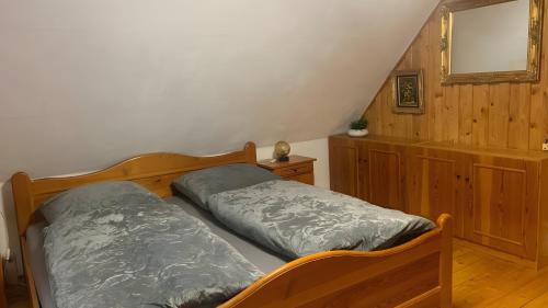 a bedroom with two beds and a mirror at Ferienhaus in Finsterbergen in Friedrichroda