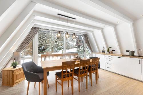 a kitchen with a dining room table and chairs at Nurdachhaus Sauerland in Kirchhundem