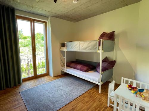 a childs room with a bunk bed and a table at Ferienwohnung Grüner Ausblick in Elzach